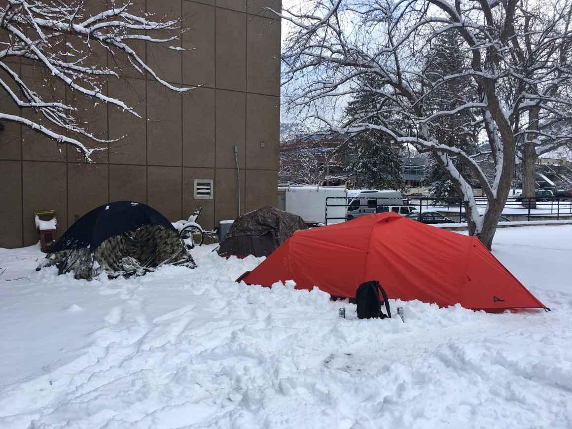 Different colored camping tents standing in snow